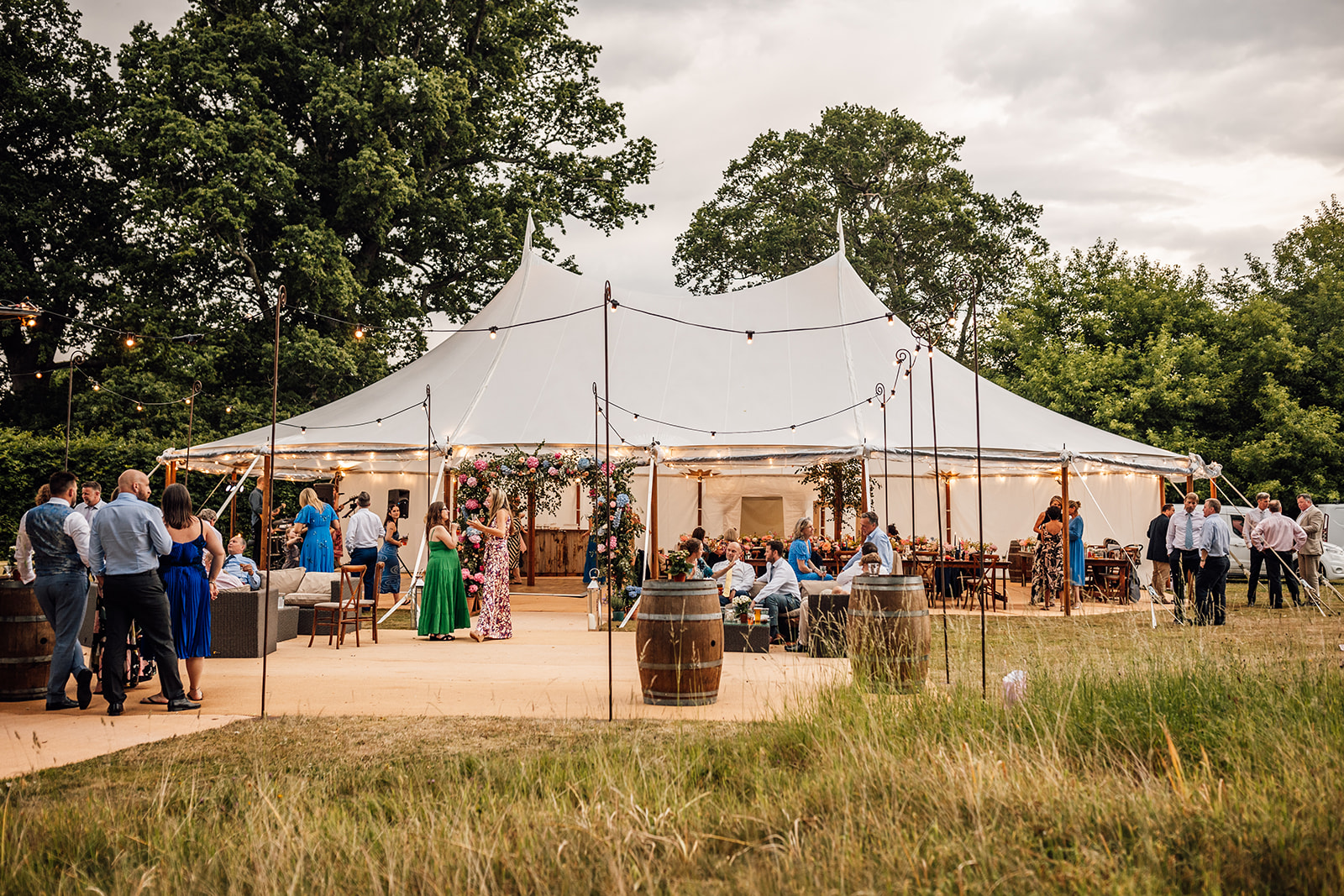 outdoor-dinner-at-bignor-park-showing-a-large-open-sided-marque